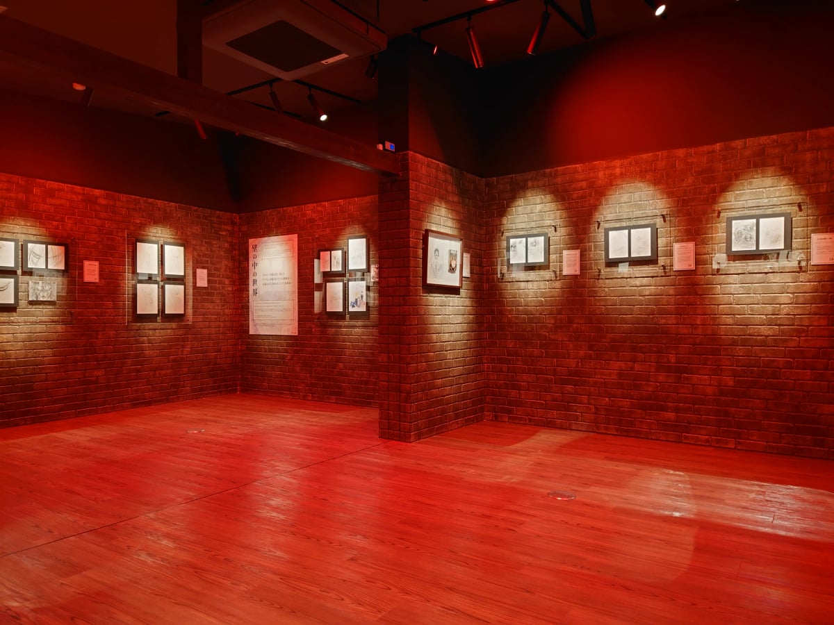 An exhibition room with exhibits on the walls at the ‘Attack on Titan in Hita Museum