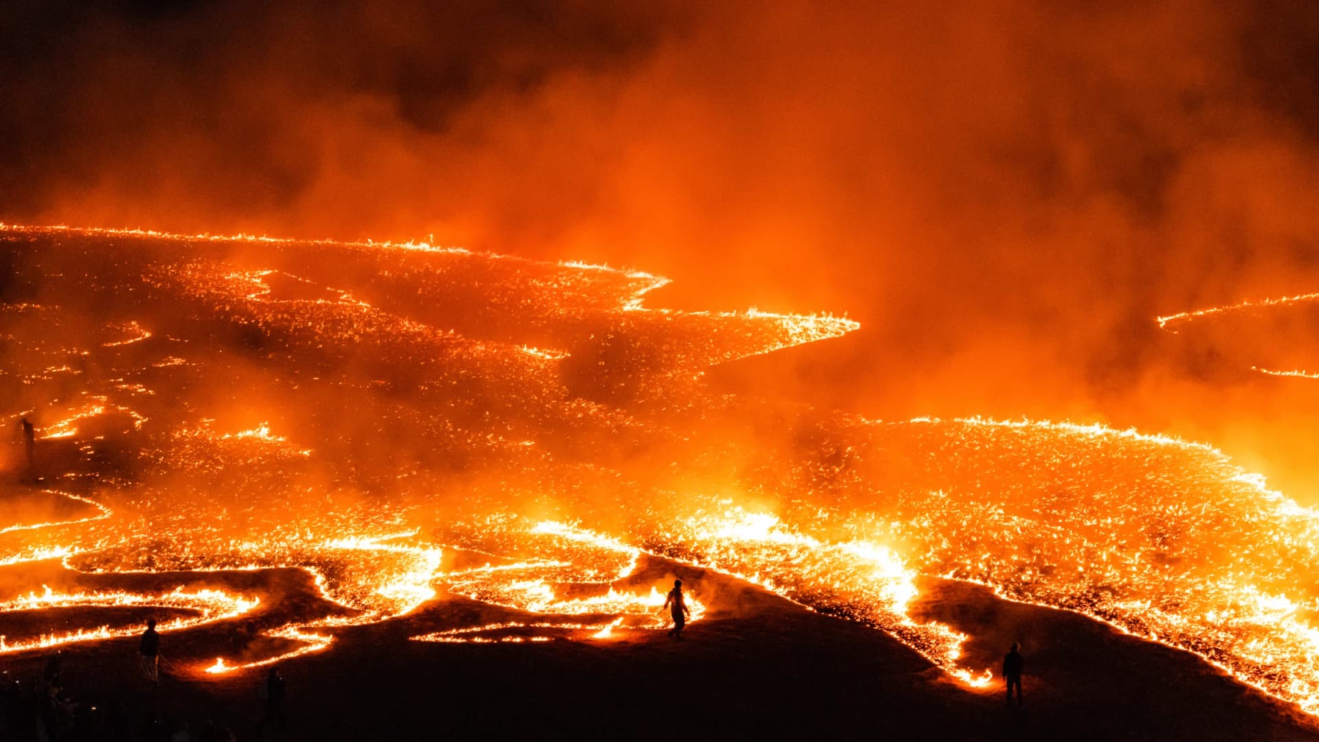 Fire sweeps across the grassland at Cape Shionomisaki during the mainland's southernmost fire festival, Wakayama