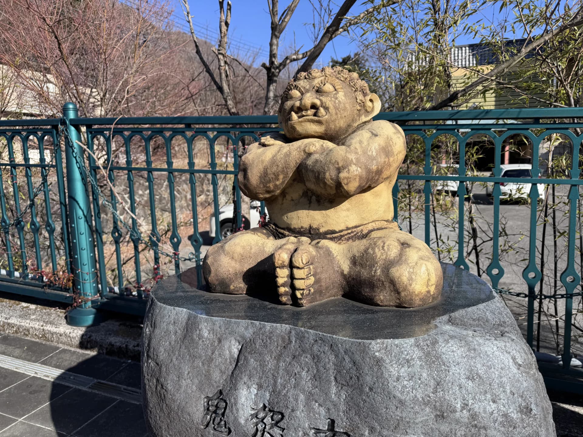A seated oni statue, arms folded, at Kinugawa Onsen, Nikko, Tochigi