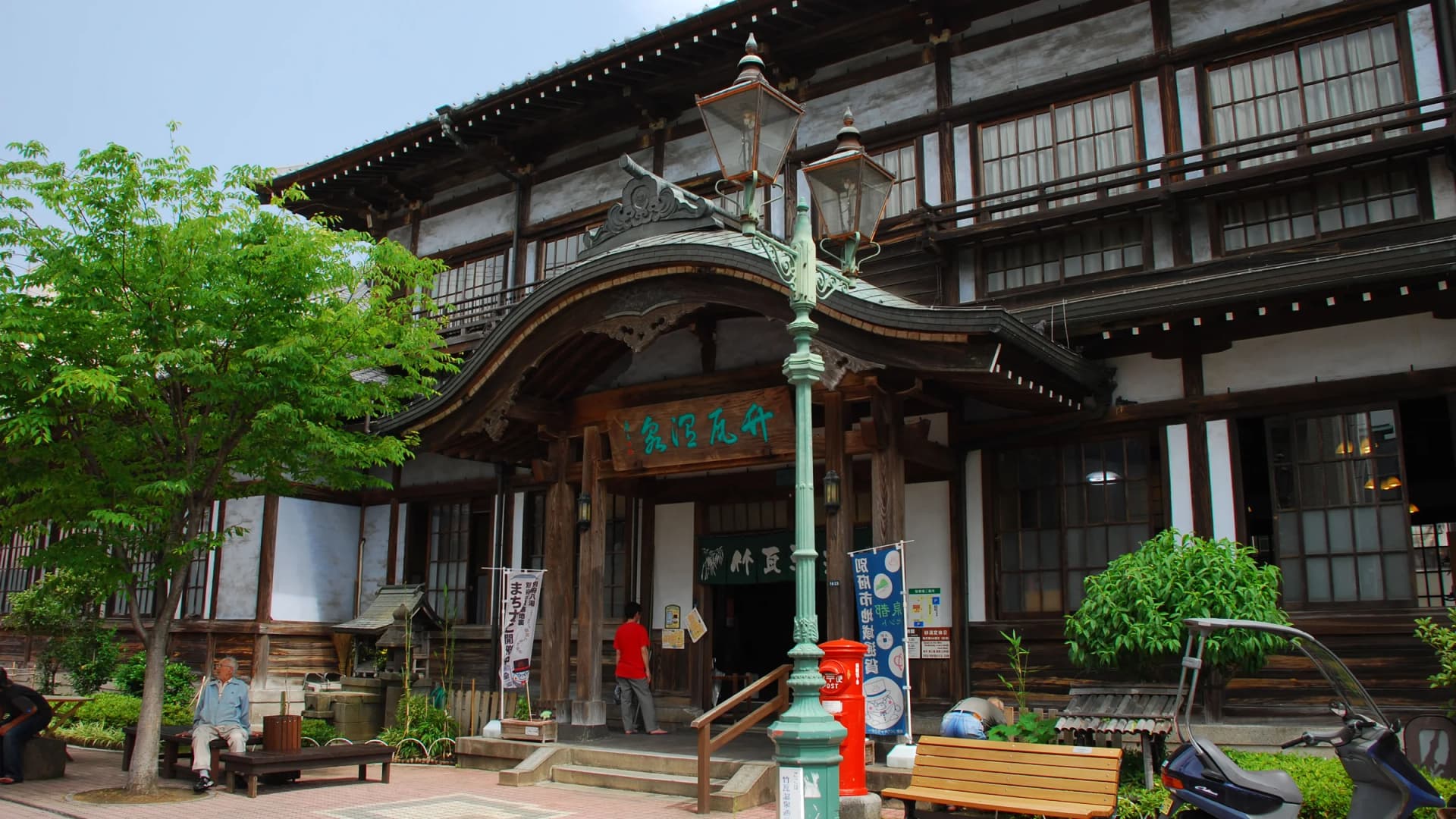The historic wooden facade and sweeping karahafu gable of Takegawara Onsen, Beppu, Oita