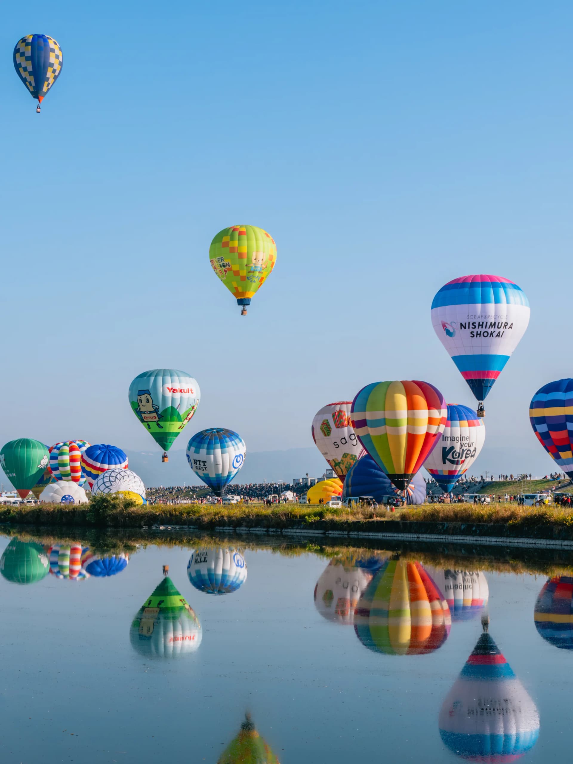 Hot air balloons rise over the Kase River at Saga International Balloon Fiesta