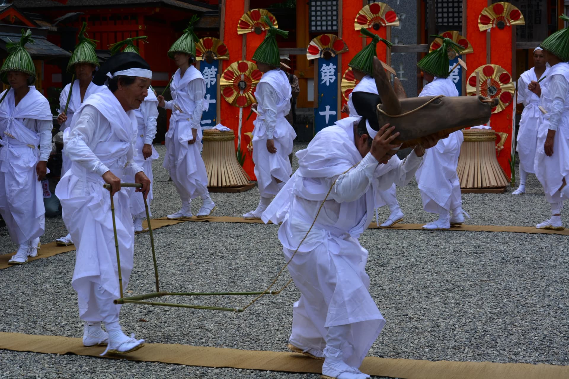 White-robed participants perform a ritual dance during the Nachi Fire Festival at Kumano Nachi Taisha, Wakayama