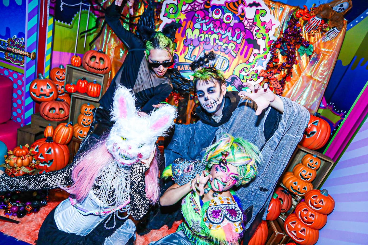 Guests in skeleton makeup, a rabbit mask and black wings at the Halloween pumpkin photo spot, KAWAII MONSTER HALLOWEEN 2026 opening party