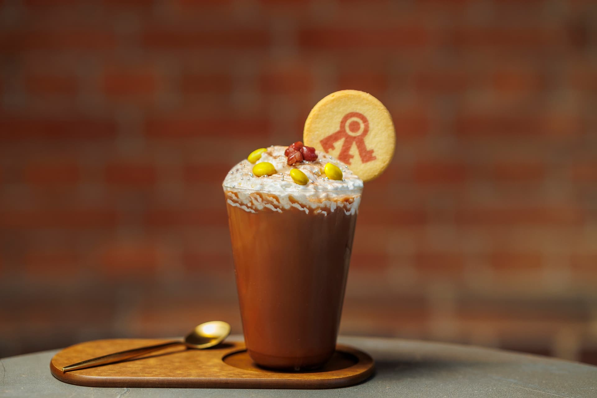 Zenzai hot chocolate topped with cream, red beans and a cookie bearing the Nara Prison Museum mark