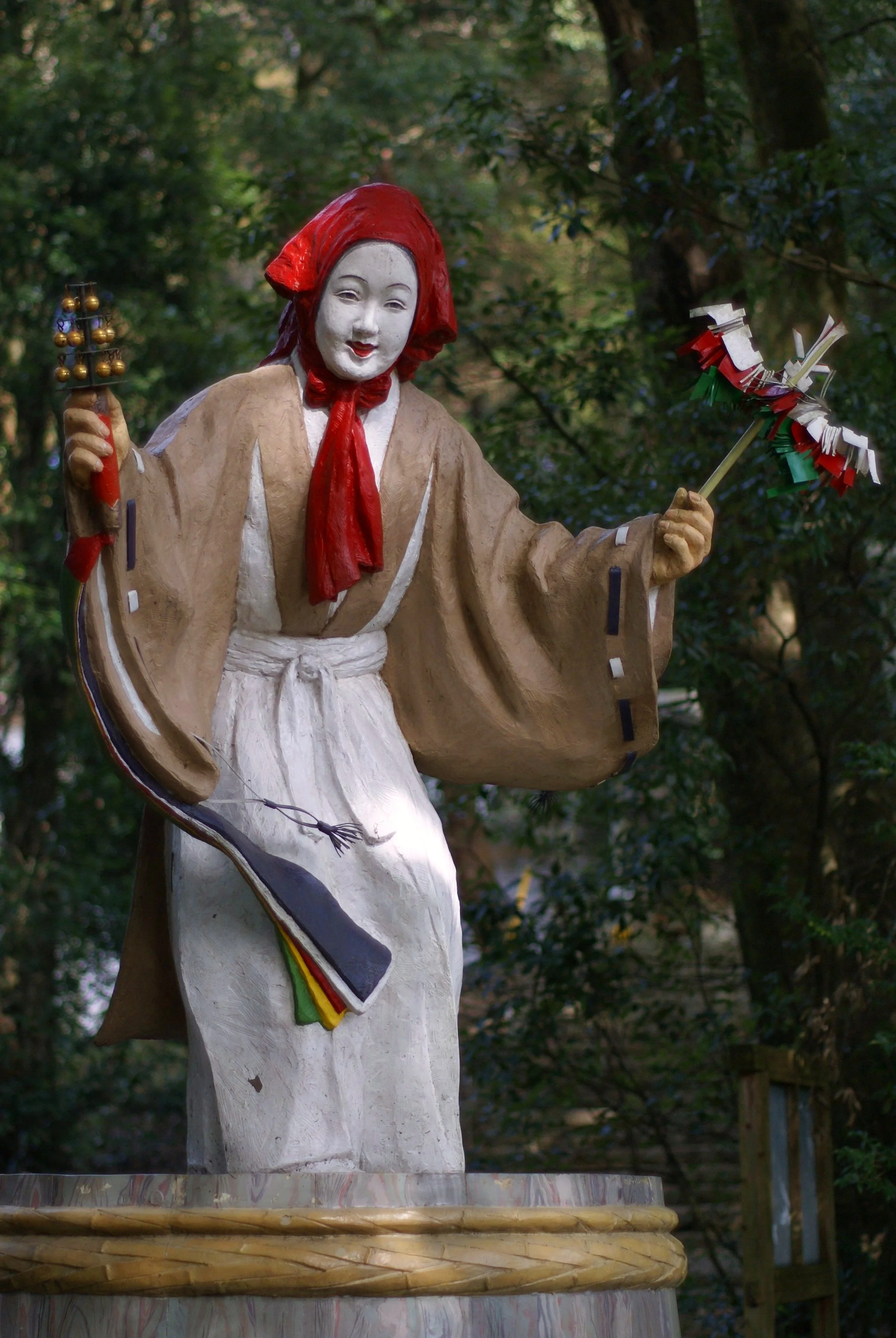 A statue of the goddess Ame-no-Uzume, holding bells and a sacred wand mid-dance, greets visitors at Amano-Iwato Shrine, Takachiho