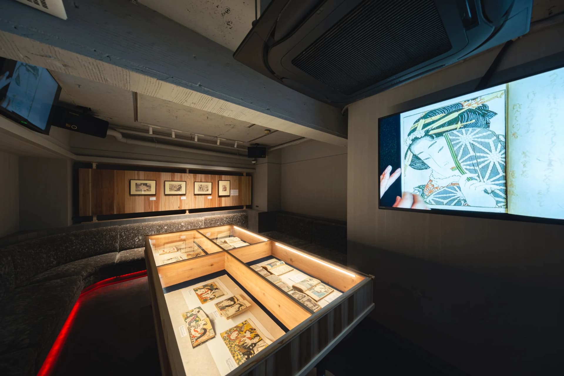 Exhibition view at BOND, with a video presentation showing pages from Kinoe no Komatsu