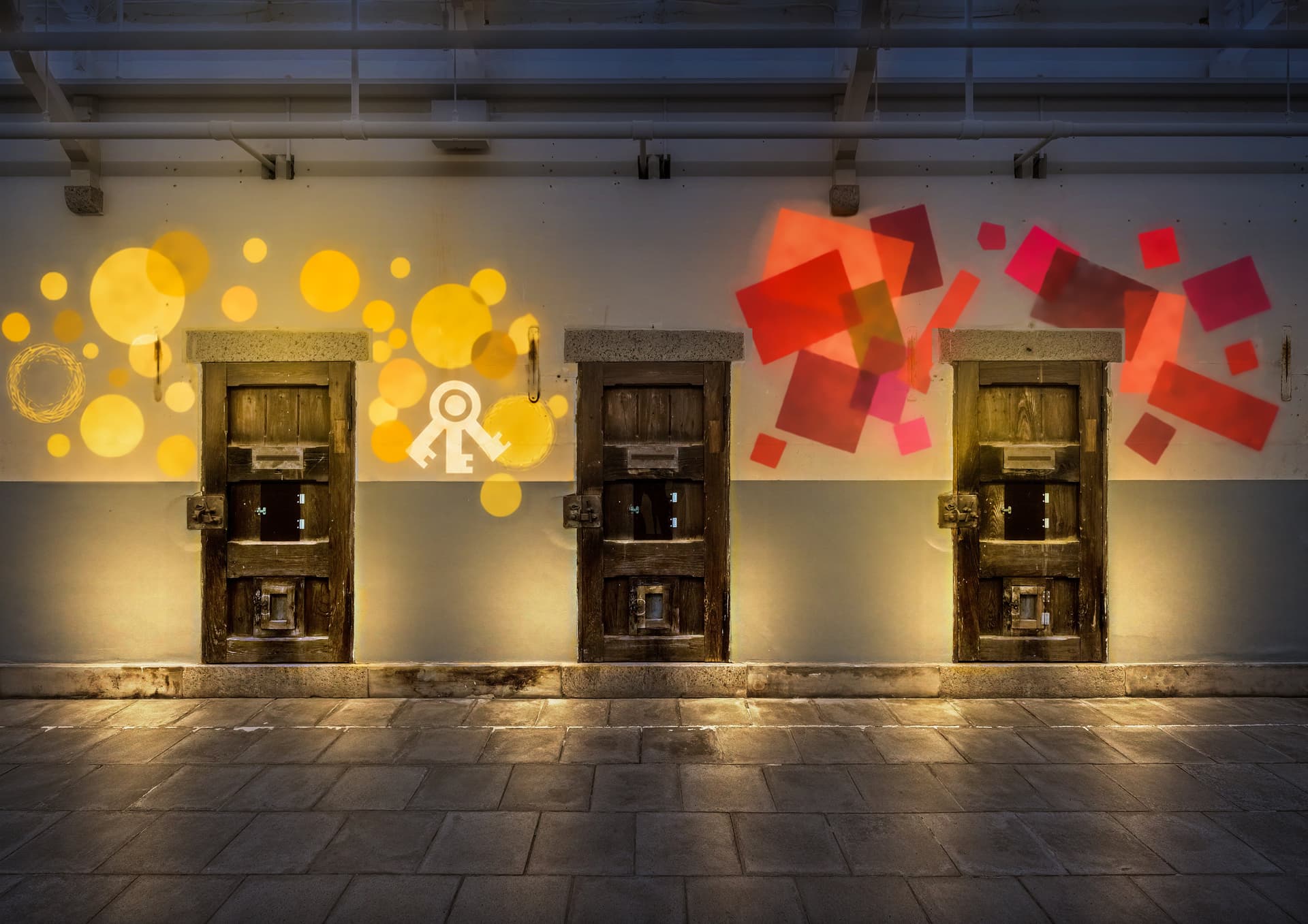 Yellow circles and red geometric shapes projected around cell doors in the preserved block (artist's impression)