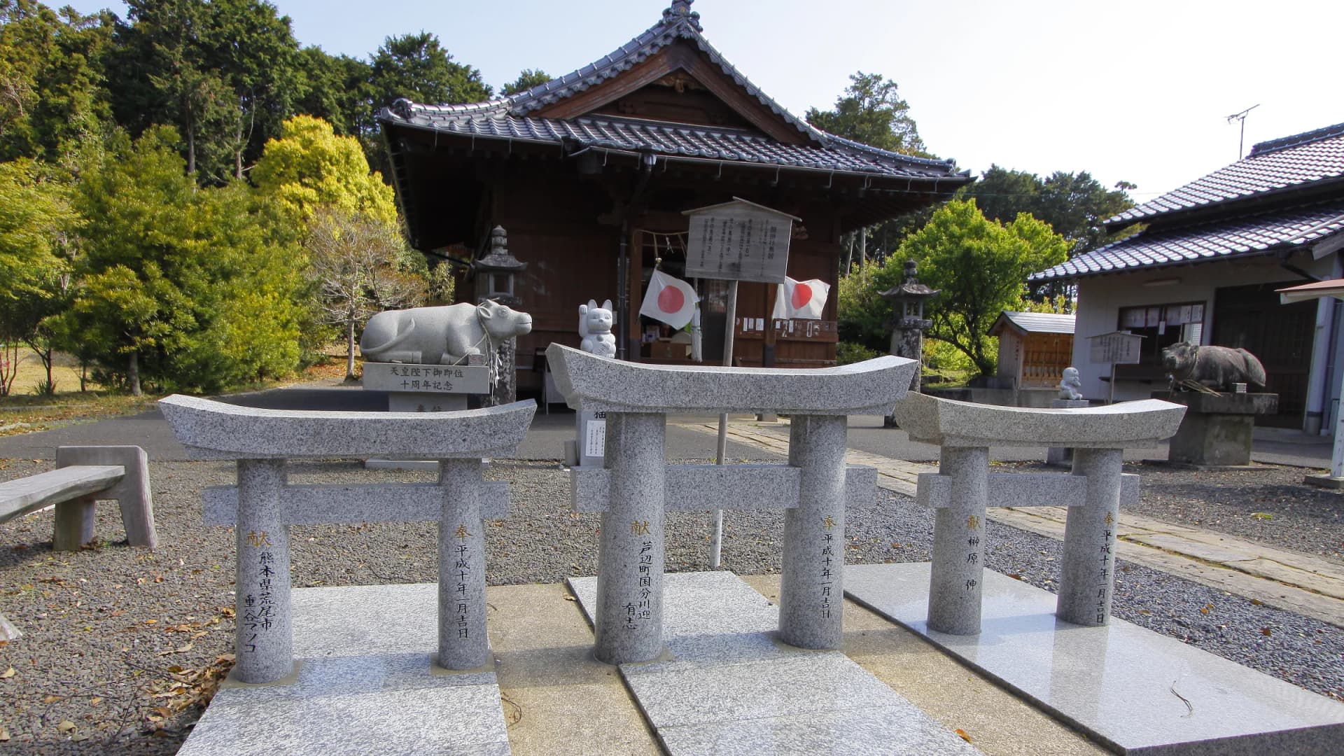 Three miniature stone torii for wish-making stand before Kunikatanushi Shrine on Iki Island, Nagasaki