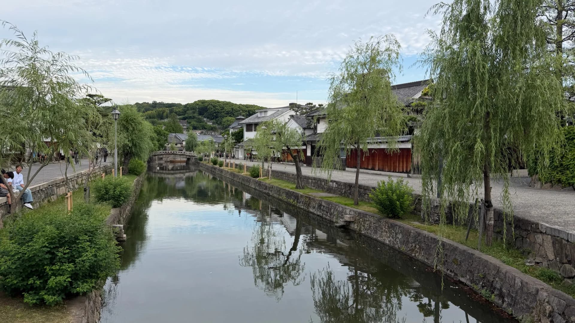 Willow trees drape over the tranquil canal of Kurashiki's Bikan Historical Quarter in Okayama